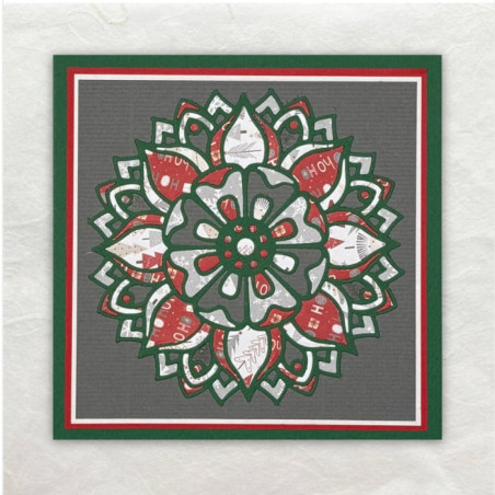 De Mandala is meerdere gestanst. Daarna zijn de stukjes designpapier in het frame van de mandala ingelegd.