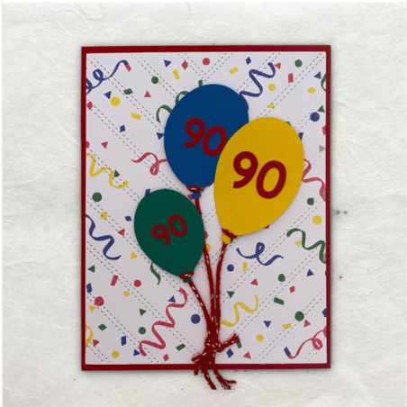 De achtergrond met de feest slingers is rond gestempeld. De ballonnen zijn uitgesneden met de Cricut.